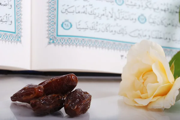 Holy Islam book, some dates and rose — Stock Photo, Image