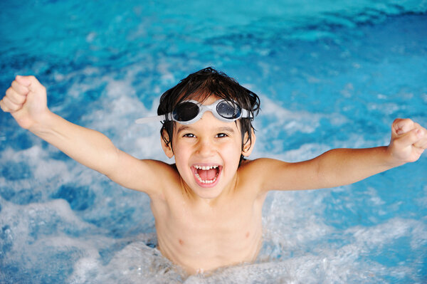 Super happy boy inside the swimming pool