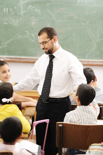Education activities in classroom at school, happy children learning — Stock Photo, Image