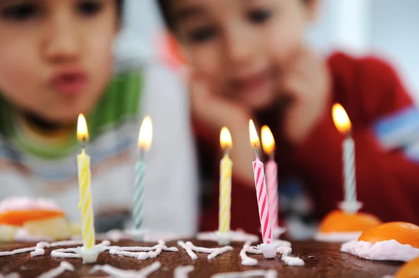 Two little boys blowing candles on cake, happy birthday party — Stock Photo, Image