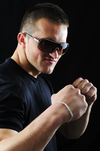 Stylish fashion young Man portrait with sunglasses on black background — Stock Photo, Image