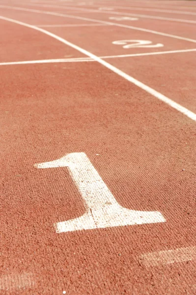 Numbers on running track, one 1 for winner — Stock Photo, Image