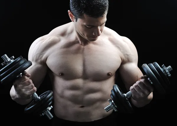 Το τέλειο αρσενικό σώμα - φοβερό bodybuilder που ποζάρει με αλτήρες — Φωτογραφία Αρχείου