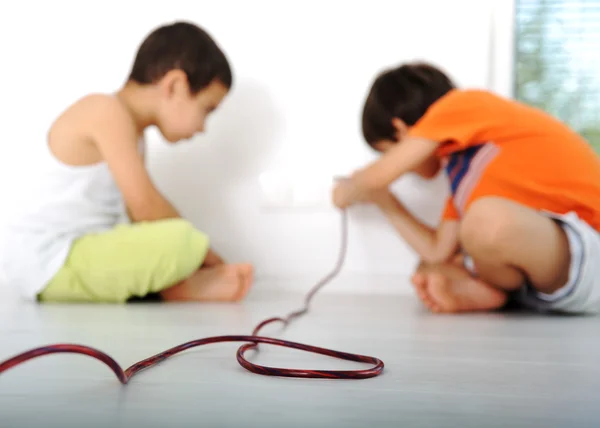 stock image Dangerous game, children experimenting with electricity