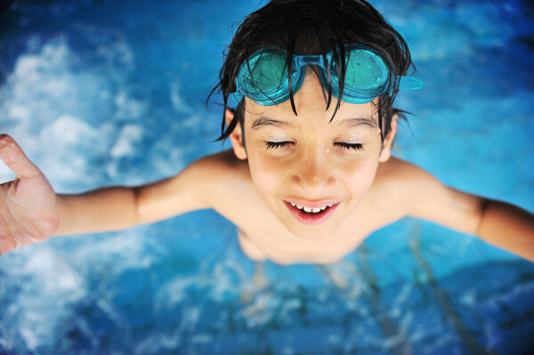 Summertime and swimming activities for happy children on the pool