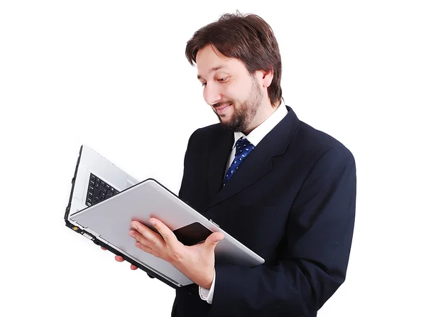 Bir kitap olarak dizüstü bilgisayar ile genç erkek ayakta — Stok fotoğraf