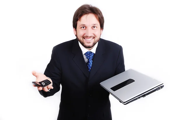 Young attractive male standing with laptop and phone — Stock Photo, Image