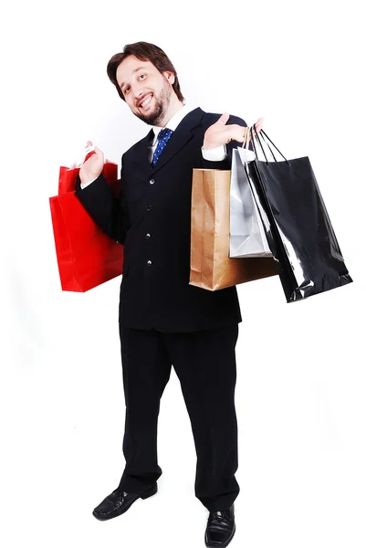 Junger attraktiver Mann im Anzug und mit Einkaufstaschen — Stockfoto