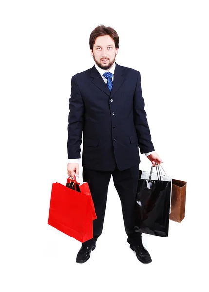 Aantrekkelijke jonge man dragen pak en bedrijf shopping tassen — Stockfoto