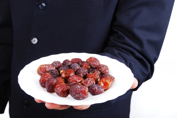Man in suit holding dates plate in front — Stock Photo, Image