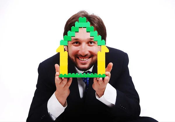 Young male holding homes made by cubes — Stock Photo, Image
