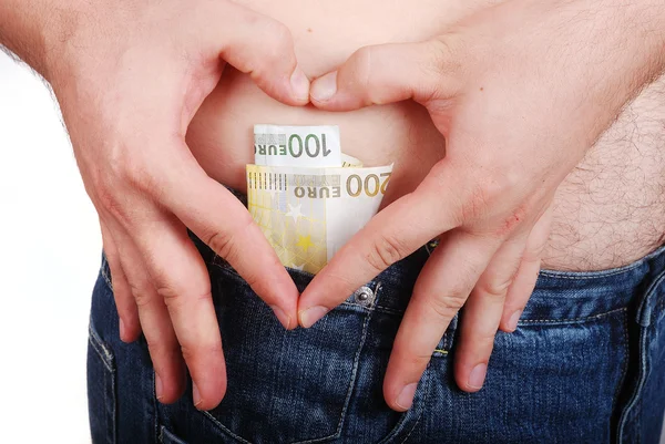 Euro em forma de coração feito com as mãos masculinas no quadril — Fotografia de Stock