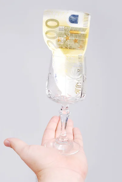 One hundred euro in glass on male hand — Stock Photo, Image