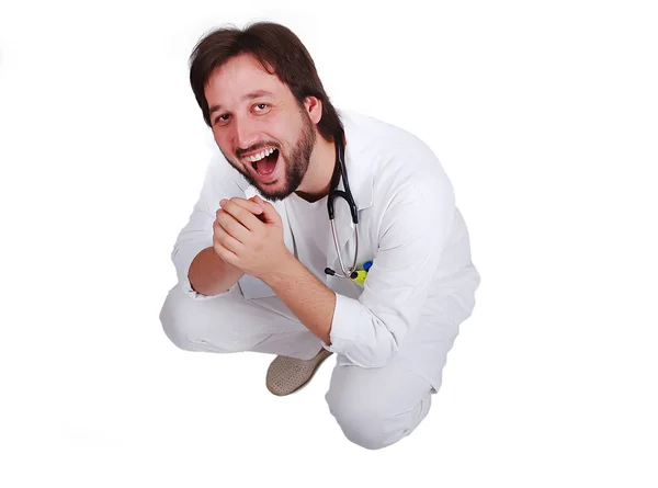 Young male doctor sitting down and laughing — Stock Photo, Image