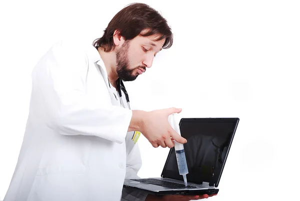 Young male doctor is taking care of laptop — Stock Photo, Image