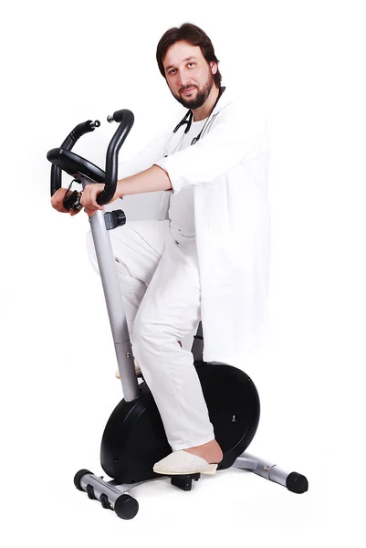 Young male doctor is riding sport bicycle — Stock Photo, Image