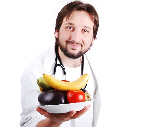 Young male doctor advicing healthy natural food — Stock Photo, Image