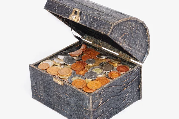 Viele Münzen in einer alten Truhe isoliert — Stockfoto