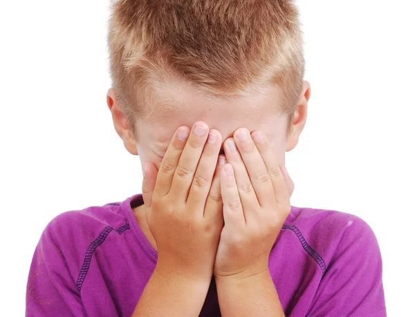 Mycket söt liten pojke med sorgligt uttryck och händer på ansikte — Stockfoto
