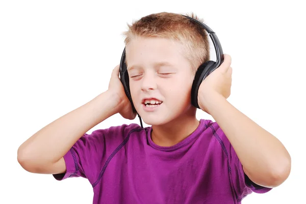 Pequeño niño agradable escuchando música con expresión pacífica en la cara —  Fotos de Stock