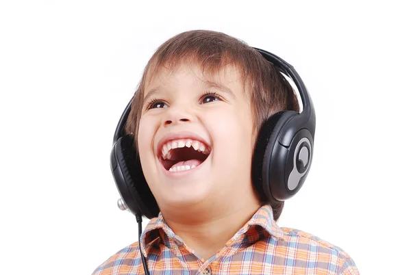 Pequeño niño agradable escuchando música con expresión pacífica en la cara —  Fotos de Stock