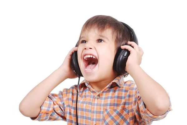 Piccolo bel ragazzo che ascolta musica con espressione pacifica sul viso — Foto Stock