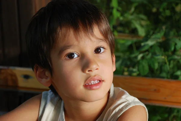 Cute male child is sitting outdoor, closeup — Stock Photo, Image