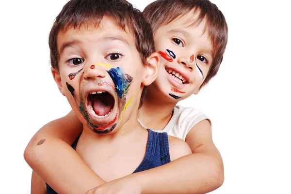 Two little cute brothers with colors on their faces — Stock Photo, Image