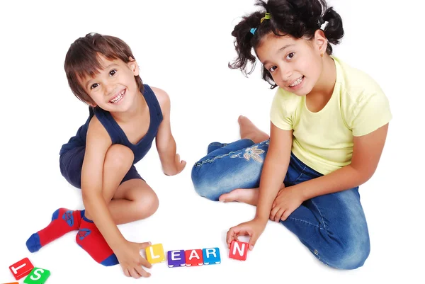 Children playing with cubes in white isolated space Stock Image
