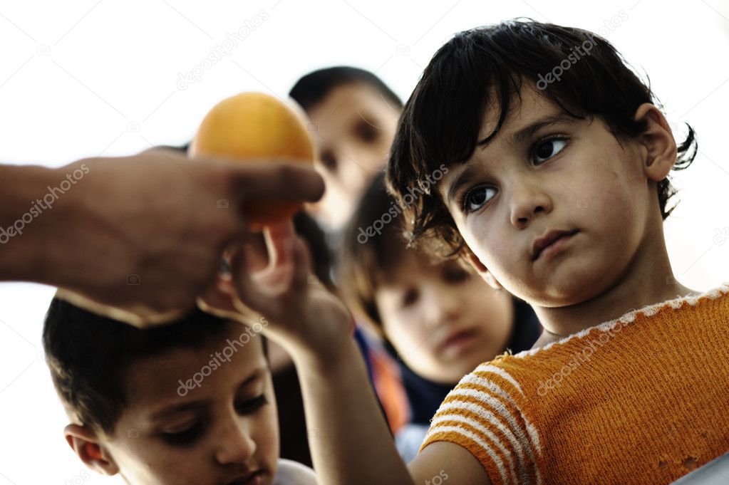 Refugee camp, poverty, hungry children receiving humanitarian food