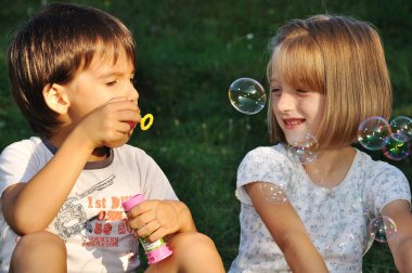 Happy childhood in summer outdoor, with bubbles clipart