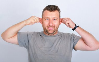Young funny man holding his ears clipart