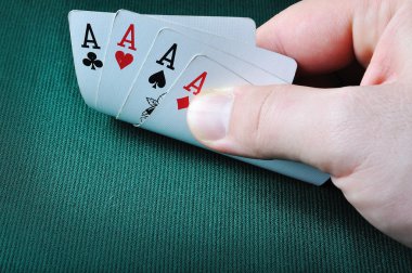 Four aces in casino on green background clipart