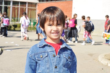 Happy children in front of the school, outdoor, summer to fall clipart