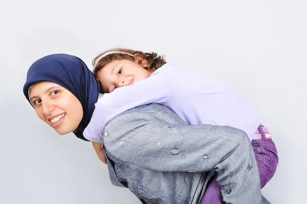Jovem muçulmana brincando com sua filha — Fotografia de Stock
