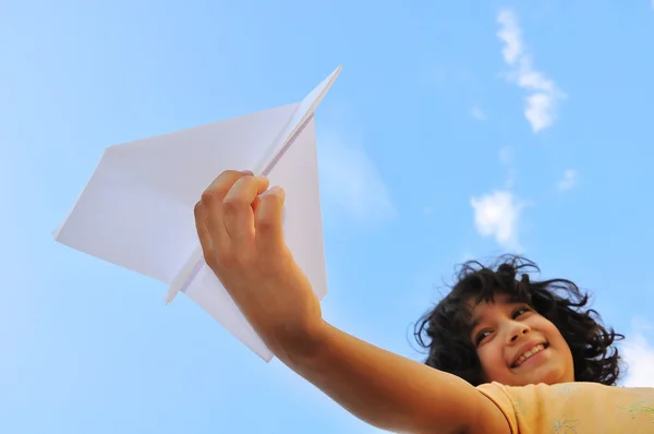 Airplane in the hand of child against the sky — Stock Photo, Image