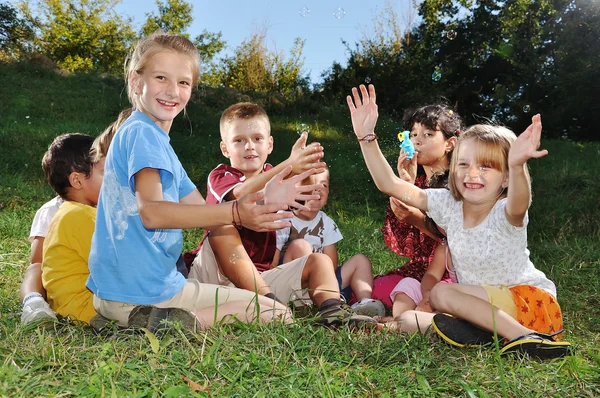 Feliz hermoso niños jugando en el suelo al aire libre —  Fotos de Stock