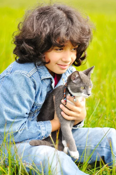Muito bonito menina com gato no prado — Fotografia de Stock