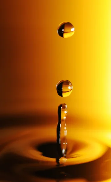 Water drop in orange and black — Stock Photo, Image