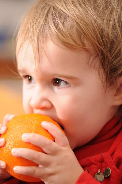 Baby and orange — Stock Photo, Image