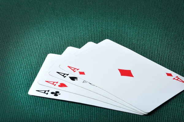 Four aces in casino on green background — Stock Photo, Image