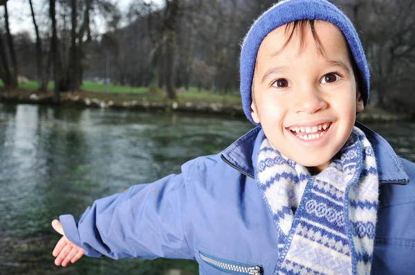 Positive kid beside the river — Stock Photo, Image