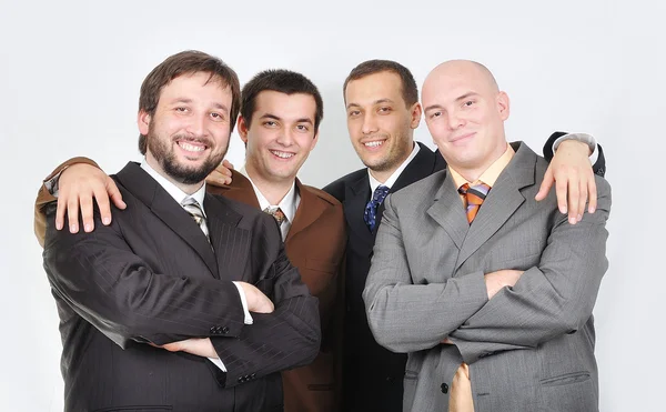 Group of young businessmen together on light background — Stock Photo, Image