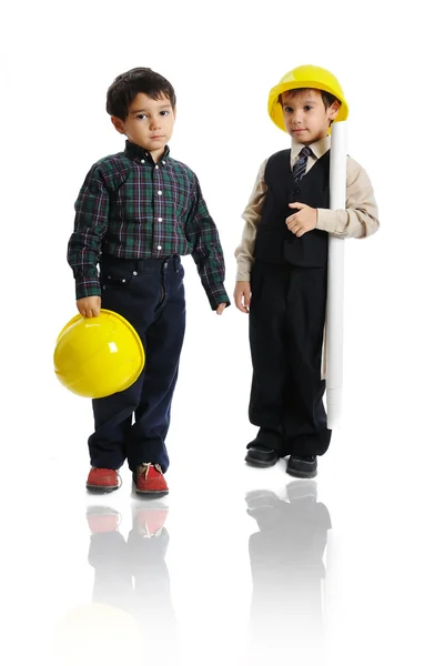 Little cute engineers isolated, kids playing together Stock Picture