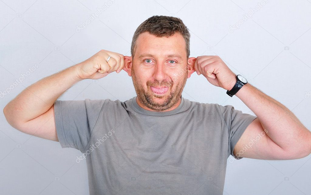 Young funny man holding his ears