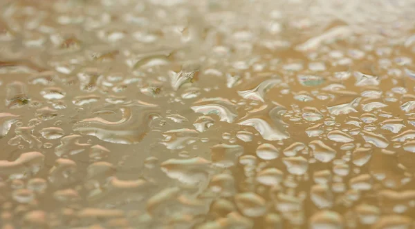 Gotas de agua doradas — Foto de Stock