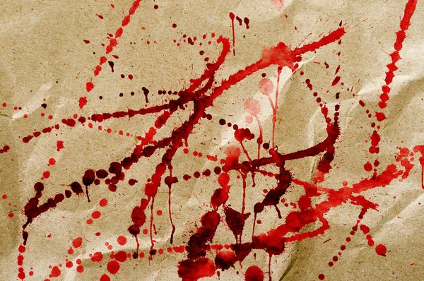 Manchas vermelhas sangrentas no cartão — Fotografia de Stock