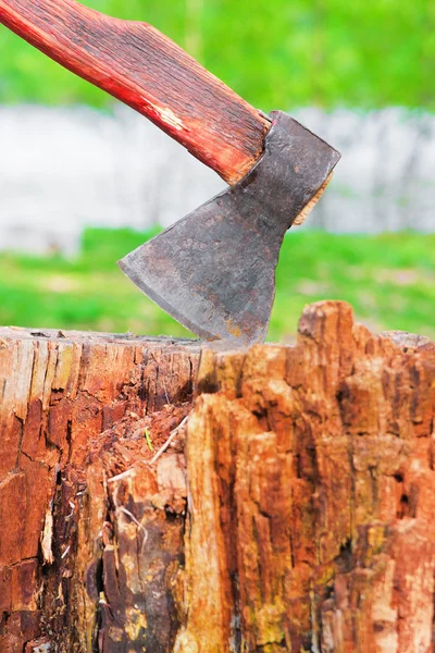 Old hatchet in wooden log — Stock Photo, Image