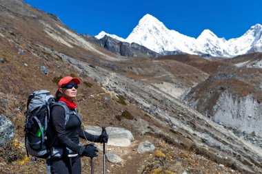Woman trekking in Himalaya Mountains clipart