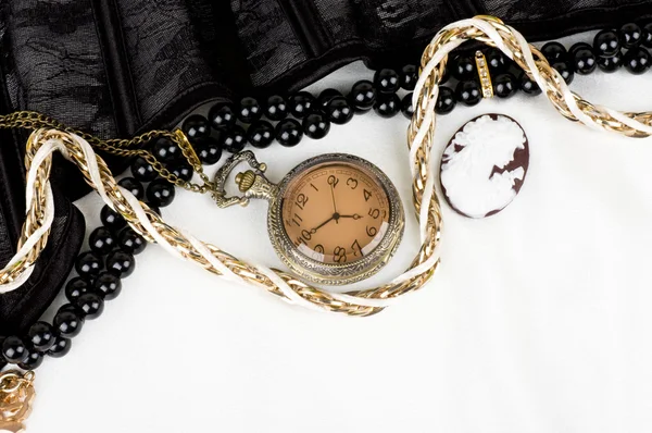 Merletto nero con forma fiore, orologio e antico cammeo su sfondo bianco — Foto Stock